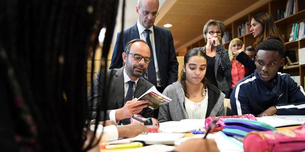 French Prime Minister Edouard Philippe speaks with pupils as he visits the Jean Perrin secondary school